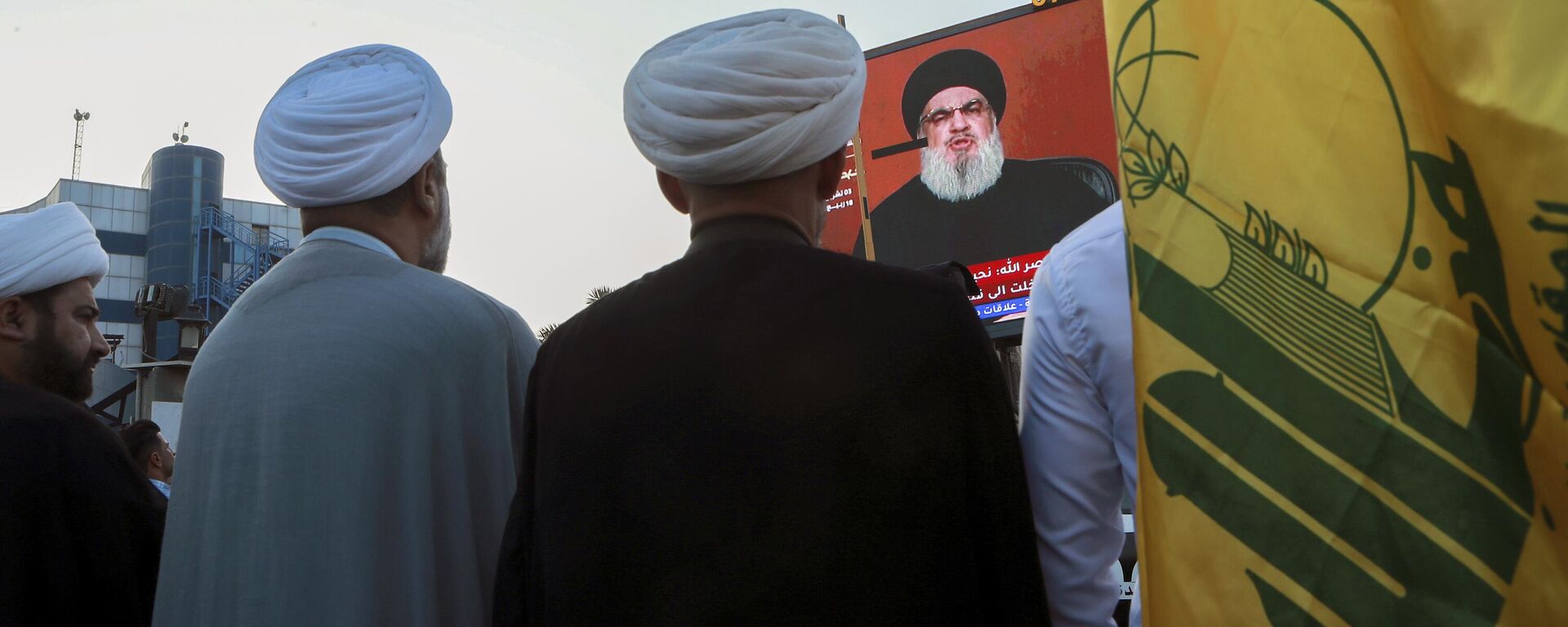 Manifestantes iraquianos assistem a um discurso do líder do Hezbollah do Líbano, Sayyed Hassan Nasrallah, em uma tela enquanto seguram bandeiras do Hezbollah durante um comício pró-Palestina em Basra, Iraque, 3 de novembro de 2023 - Sputnik Brasil, 1920, 05.11.2023