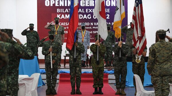 Fuzileiros navais das Filipinas, dos EUA e da Coreia do Sul e membro das Forças de Autodefesa do Japão carregam suas bandeiras nacionais durante cerimônia de abertura dos exercícios militares Kamandag no quartel-general dos fuzileiros navais filipinos em Taguig, Filipinas, 3 de outubro de 2022 - Sputnik Brasil