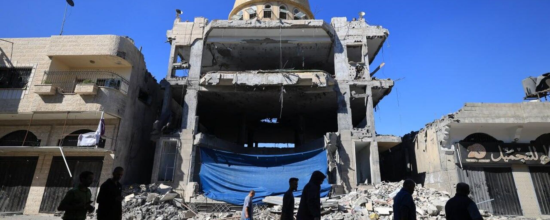 Palestinos passam pelos escombros da mesquita al-Saqa, danificada durante um ataque israelense, em Khan Yunis, no sul da Faixa de Gaza, 16 de novembro de 2023 - Sputnik Brasil, 1920, 16.11.2023