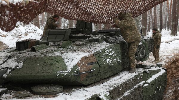 Membros da tripulação de tanques ucranianos da 21ª Brigada Mecanizada estão em um tanque de batalha Leopard 2A5 de fabricação alemã coberto de neve perto do front de combate em um local não revelado na direção de Lyman, região de Donetsk, 21 de novembro de 2023 - Sputnik Brasil