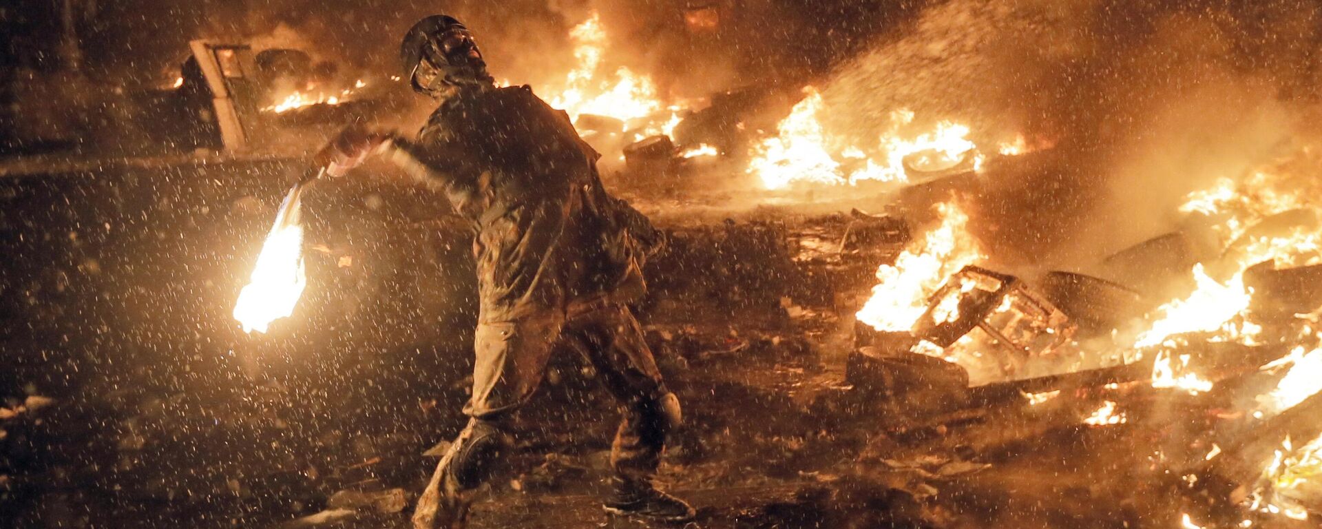 Um manifestante lança um coquetel molotov durante confrontos com a polícia no centro de Kiev, Ucrânia. - Sputnik Brasil, 1920, 30.12.2023