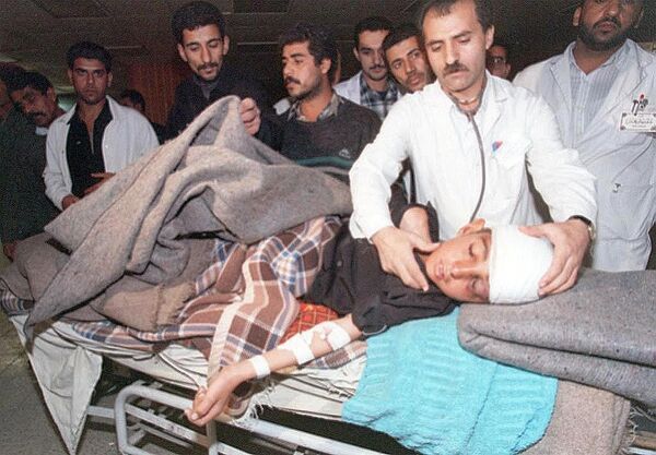 Médico iraquiano examina um menino ferido em um abrigo do Centro Médico Saddam, em Bagdá, após um ataque aéreo no final do dia 17 de dezembro de 1998. Depois do ataque, pelo menos cinco mísseis caíram em bairros residenciais e administrativos da capital. Um hospital e uma maternidade foram atingidos, segundo relatos. - Sputnik Brasil