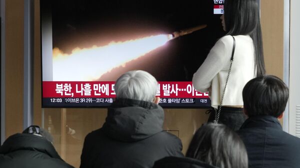 Uma tela de TV mostra uma imagem de arquivo do lançamento de míssil da Coreia do Norte durante um programa de notícias na estação ferroviária de Seul em Seul. Coreia do Sul, 28 de janeiro de 2024 - Sputnik Brasil