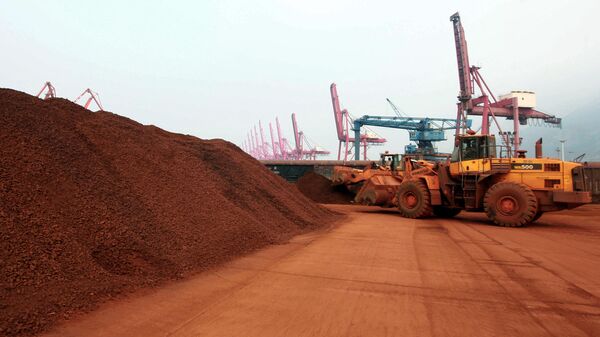 Homem dirige trator que transporta solo contendo minerais de terras raras para ser carregado em um porto em Lianyungang, província de Jiangsu, no leste da China, em 5 de setembro de 2010 - Sputnik Brasil