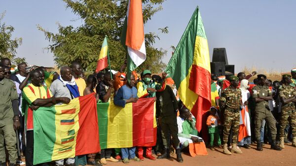 Pessoas brandem bandeiras do Níger, Mali e Burkina Faso durante uma reunião em Niamey, em 29 de dezembro de 2023 - Sputnik Brasil