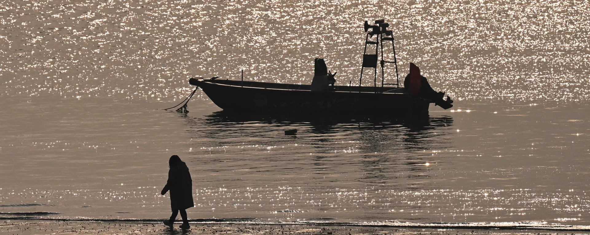 Pessoa caminha em praia em frente à ilha Kinmen de Taiwan, em Xiamen, no sudeste da província chinesa de Fujian, 12 de janeiro de 2024 - Sputnik Brasil, 1920, 18.02.2024