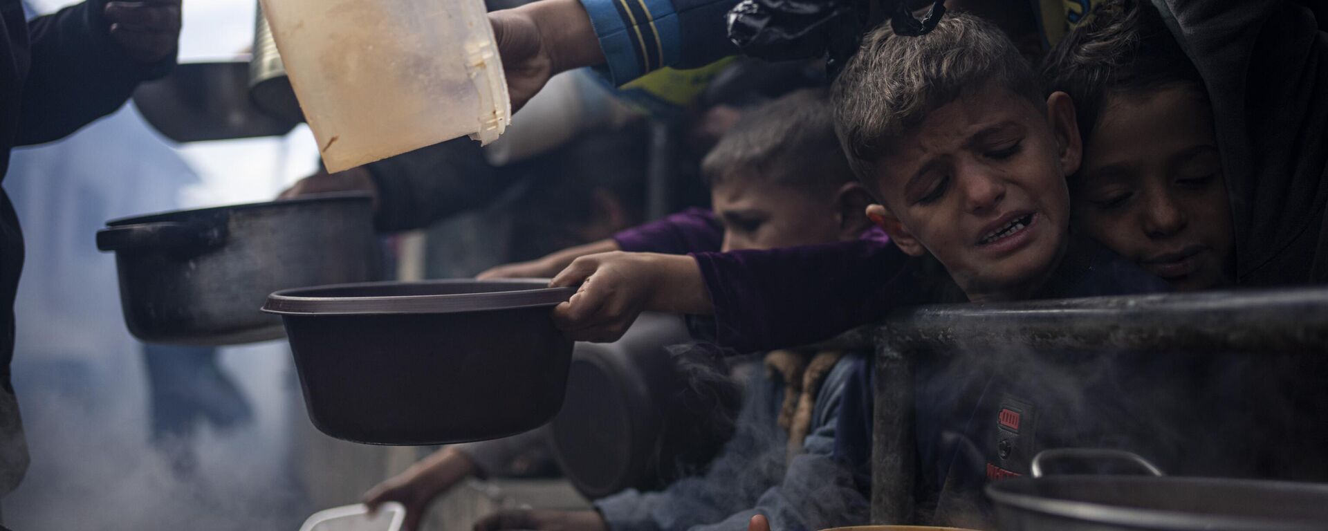 Palestinos fazem fila para refeição fornecida por ajuda humanitária em Rafah. Faixa de Gaza, 16 de fevereiro de 2024 - Sputnik Brasil, 1920, 04.03.2024