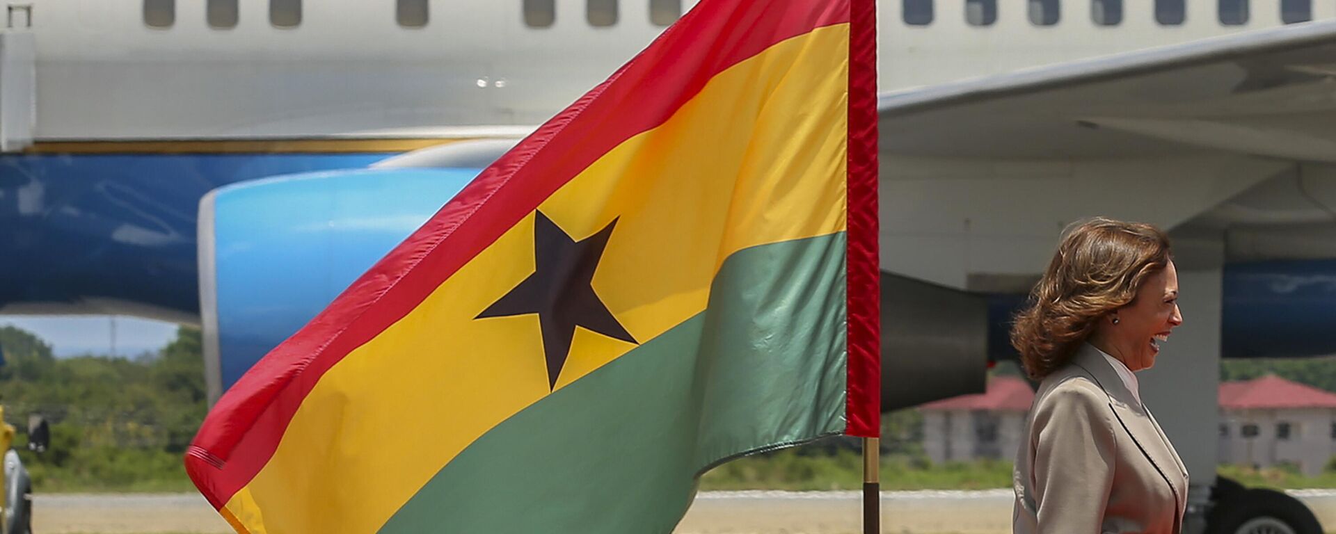 A vice-presidente dos EUA, Kamala Harris, sorri ao passar por uma bandeira de Gana ao chegar na capital, Acra, em 26 de março de 2023 - Sputnik Brasil, 1920, 22.03.2024