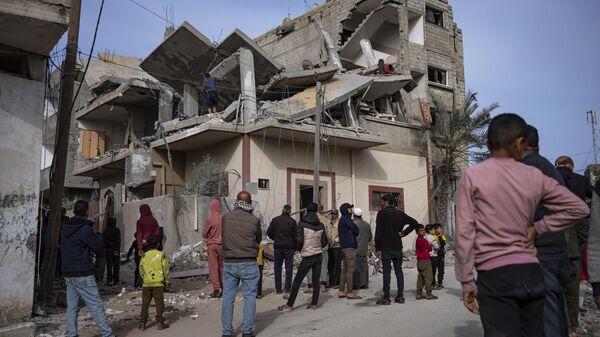 Palestinos procuram corpos em casa atingida por ataque israelense em Rafah. Faixa de Gaza, 27 de março de 2024 - Sputnik Brasil
