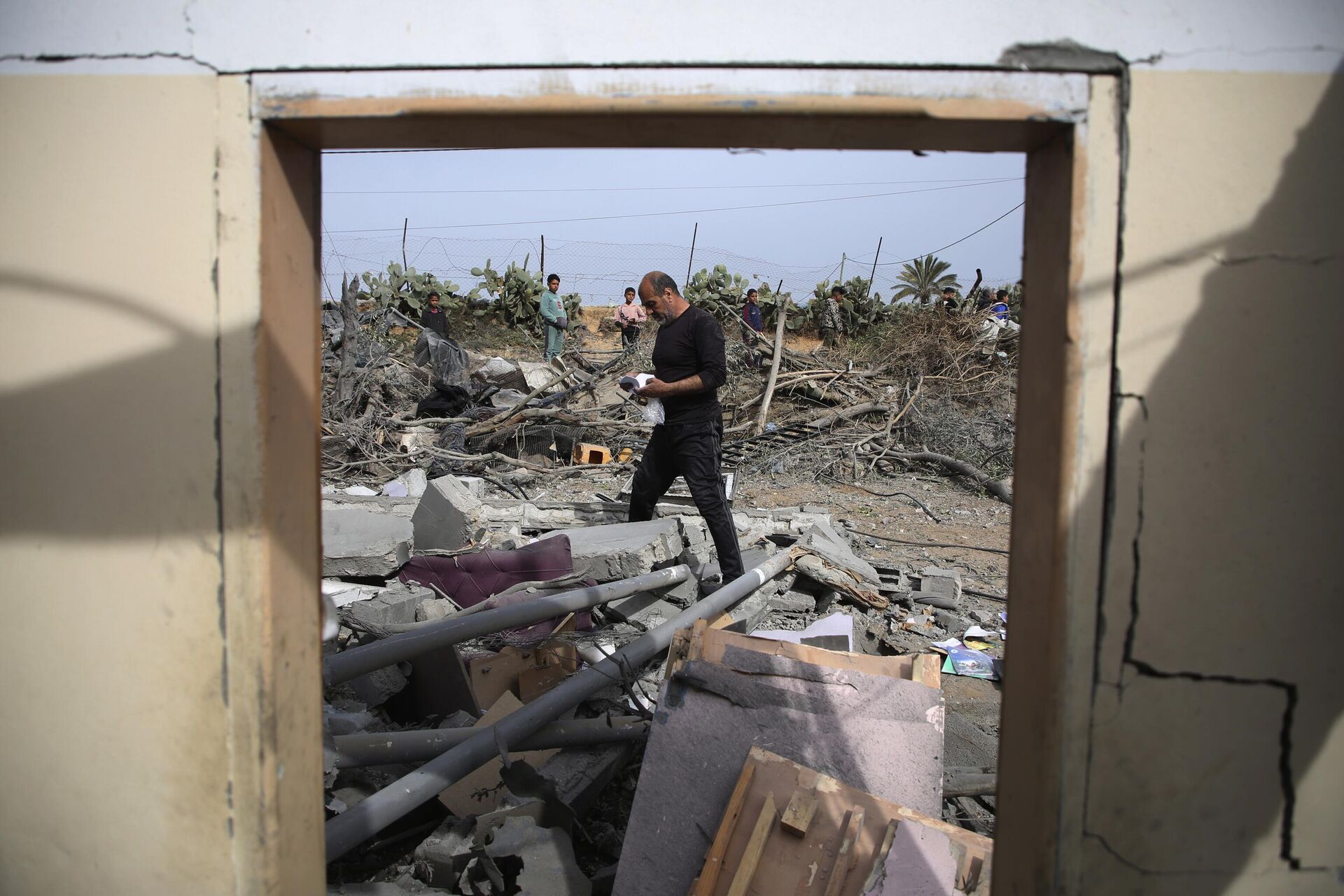 Palestinos inspecionam as ruínas de um prédio residencial após ataque aéreo israelense em Rafah, Faixa de Gaza, em 29 de março de 2024 - Sputnik Brasil, 1920, 19.04.2024