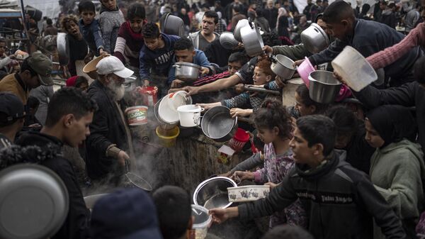 Palestinos fazem fila para uma refeição em Rafah. Faixa de Gaza, 21 de dezembro de 2023 - Sputnik Brasil