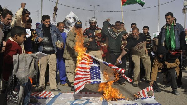 Manifestantes iraquianos queimando as bandeiras dos EUA e de Israel como gesto de apoio à Palestina - Sputnik Brasil
