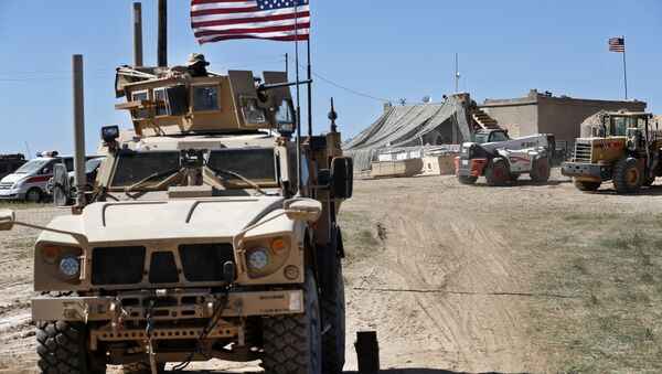 Soldado norte-americano, à esquerda, sentado em veículo blindado perto da tensa linha de frente entre o Conselho Militar de Manbij, apoiado pelos EUA, e os combatentes apoiados pelos turcos, em Manbij, norte da Síria, 4 de abril de 2018 - Sputnik Brasil