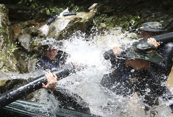 Salvadores tailandeses instalam tubos durante a operação de resgate dos meninos da caverna inundada - Sputnik Brasil