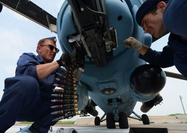 Técnicos aeronáuticos examinando um helicóptero Mi-35 durante manobras no aeródromo de Chernigovka na região de Primorie - Sputnik Brasil