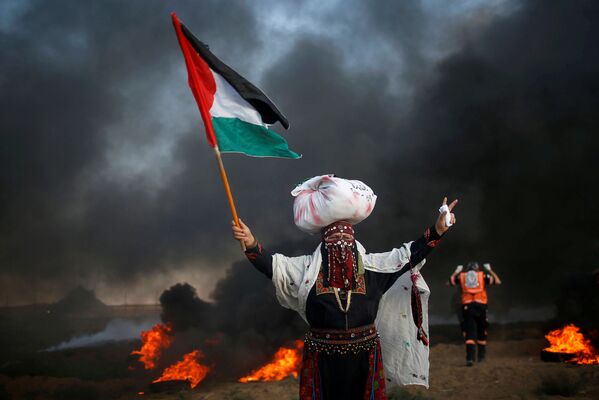 Mulher com uma bandeira palestina durante um protesto contra o bloqueio da Faixa de Gaza por Israel - Sputnik Brasil