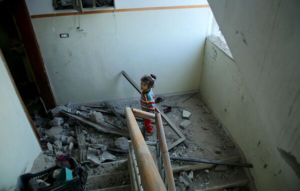 Menina em um prédio residencial atingido por mísseis israelenses na Faixa de Gaza - Sputnik Brasil