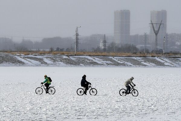 Pessoas andam de bicicleta na superfície congelada da represa da central hidroelétrica de Novossibirsk - Sputnik Brasil