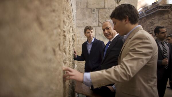 In this Jan. 22, 2013 file photo, Israeli Prime Minister Benjamin Netanyahu, center, prays with his sons Yair, background, and Avner, right, at the Western Wall, the holiest site where Jews can pray, in Jerusalem's Old City. - Sputnik Brasil