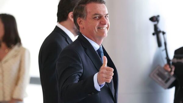O presidente Jair Bolsonaro acena para os fotógrafos no Palácio do Planalto - Sputnik Brasil