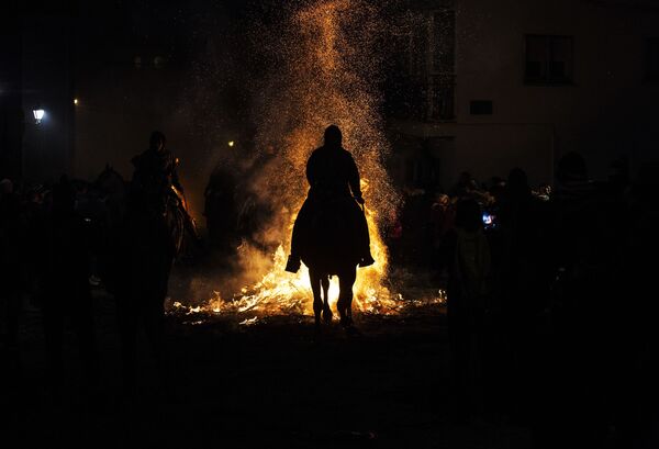 Homem montado em cavalo admira fogueira do festival anual Las Luminarias - Sputnik Brasil