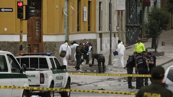 Policiais e investigadores inspecionam o local onde uma bomba explodiu perto da Praça de Touros Santamaria, em Bogotá, Colômbia - Sputnik Brasil