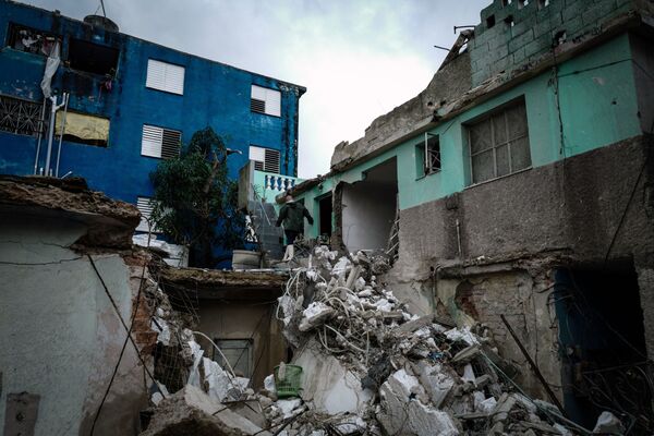 Residentes do bairro Regla caminham por escombros de prédios depois do tornado na capital de Cuba - Sputnik Brasil
