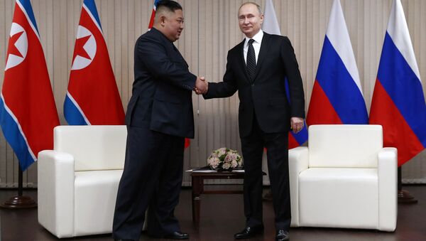 Presidente russo Vladimir Putin e o líder norte-coreano Kim Jong-un apertam as mãos durante cúpula na Universidade Federal do Extremo Oriente, em Vladivostok, Rússia, 25 de abril de 2019 - Sputnik Brasil