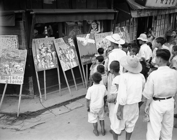 Habitantes da cidade de Taegu olham para cartazes expostos na rua, parte do programa de propaganda da coalizão ocidental, durante a Guerra da Coreia - Sputnik Brasil