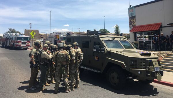 Policiais armados se reúnem ao lado de um veículo blindado do FBI perto do shopping Cielo Vista, em El Paso, no Texas - Sputnik Brasil