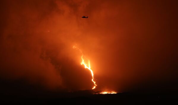 Helicóptero sobrevoa o vulcão Piton de la Fournaise, enquanto a lava desce pela encosta este-sudeste, na ilha de Reunião, no oceano Índico, 13 de agosto de 2019 - Sputnik Brasil