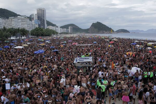 Foliões dançam e curtem o início do Carnaval na praia de Copacabana, no Rio de Janeiro - Sputnik Brasil
