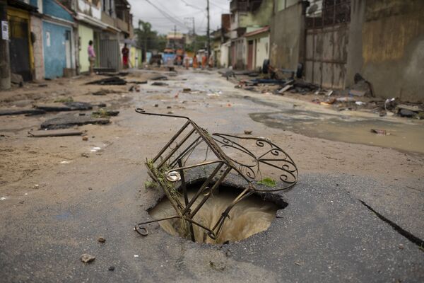 Cadeira de ferro cobre buraco aberto no asfalto em rua do bairro de Realengo - Sputnik Brasil