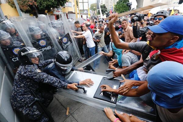 Manifestantes oposicionistas entram em confronto com policiais venezuelanos em Caracas - Sputnik Brasil