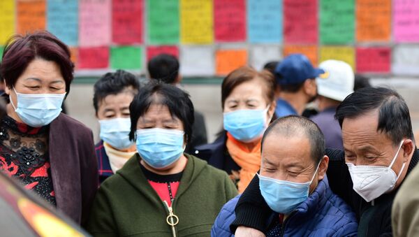 Chineses usando máscaras protetoras olham anúncios de vagas em emprego, na província de Shandong, na China, 8 de abril de 2020 - Sputnik Brasil