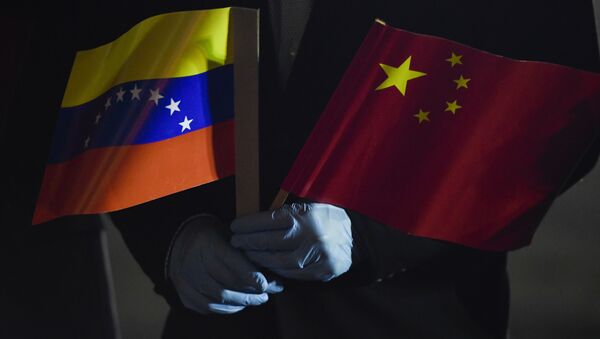 O ministro das Relações Exteriores da Venezuela, Jorge Arreaza, segura bandeiras venezuelana e chinesa - Sputnik Brasil