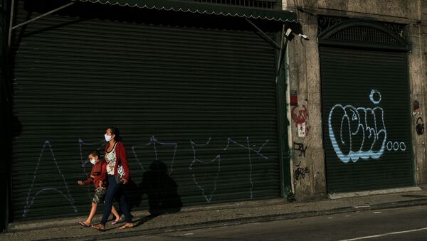 Pedestres passam em frente a um comércio fechado durante a pandemia no Rio de Janeiro - Sputnik Brasil