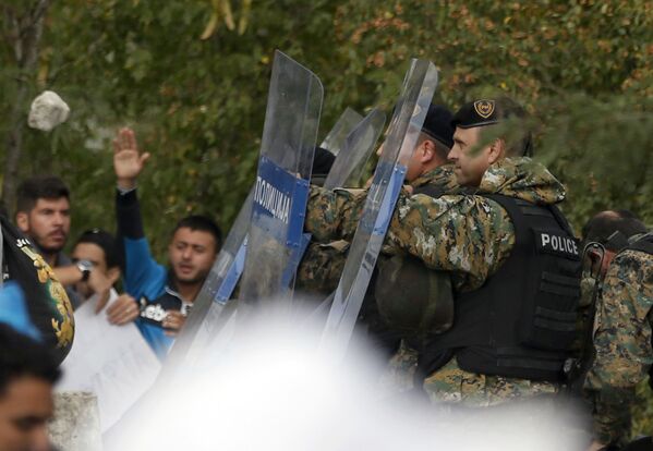 Confronto entre policiais e imigrantes na fronteira entre Grécia e Macedônia - Sputnik Brasil