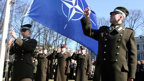 Funcionários da Letônia durante cerimônia de hasteamento da bandeira da OTAN em frente ao Castelo da Presidência em Riga - Sputnik Brasil