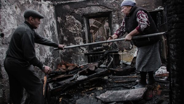 Moradores de uma casa destruída em Donetsk, na Ucrânia - Sputnik Brasil