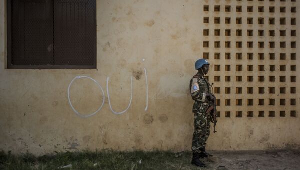 Em 14 de dezembro, na cidade de Bangui, um soldado da ONU na frente de uma parede com a inscrição que diz Sim em francês - Sputnik Brasil