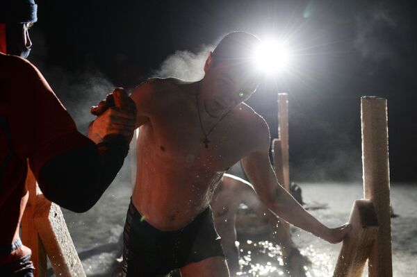 Homem participa de mergulhos noturnos de batismo no lago Shartash, em Ecaterimburgo - Sputnik Brasil