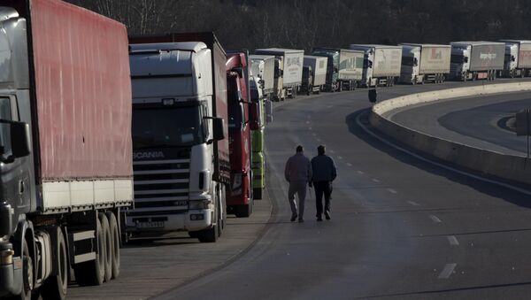 Truck drivers walk next to parked trucks as protesting farmers (not pictured) block the road leading to the border station of Greece with Bulgaria during a demonstration against planned pension reforms near the Greek village of Promachonas. - Sputnik Brasil