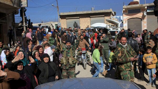 Residents of Nubul and al-Zahraa, along with forces loyal to Syria's President Bashar al-Assad, celebrate after the siege of their towns was broken, northern Aleppo countryside, Syria, in this handout picture provided by SANA on February 4, 2016 - Sputnik Brasil