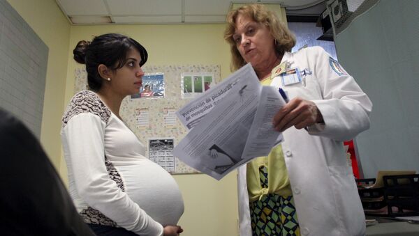 Nancy Trinidad, who is 32 weeks pregnant, listens to the explanation of a doctor about how to prevent Zika, Dengue and Chikungunya viruses at a public hospital in San Juan, Puerto Rico, February 3, 2016 - Sputnik Brasil