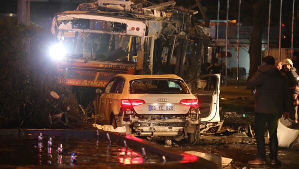A man stands next to a burnt out bus after a blast in Ankara on March 13, 2016 - Sputnik Brasil