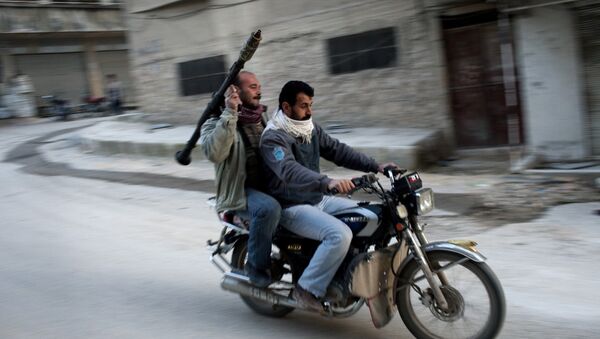 Supporters of the Free Syrian Army ride a motorcycle with a rocket-propelled grenade in Kafar Taharim, Syria. - Sputnik Brasil