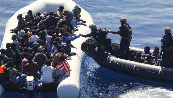 German Navy sailors surround a boat with more than 100 migrants near the German combat supply ship 'Frankfurt am Main' during EUNAVFOR Med, also known as Operation Sophia, in the Mediterranean Sea off the coast of Libya, Tuesday, March 29, 2016 - Sputnik Brasil