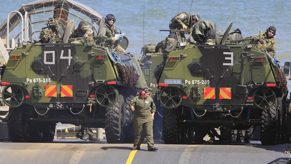 Soldiers park their amphibious vehicles on a ship as they participate in a massive amphibious landing during NATO sea exercises BALTOPS 2015 that are to reassure the Baltic Sea region allies in the face of a resurgent Russia, in Ustka, Poland, Wednesday, June 17, 2015 - Sputnik Brasil
