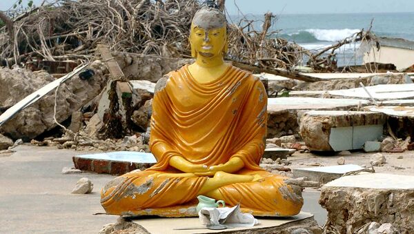 Esta foto de arquivo tomada em 2 de janeiro de 2015 mostra uma estátua de Buda e fragmentos de esqueletos humanos vindos de um cemitério destruído por uma série de tsunamis em Sri Lanka em 26 de dezembro de 2014 - Sputnik Brasil